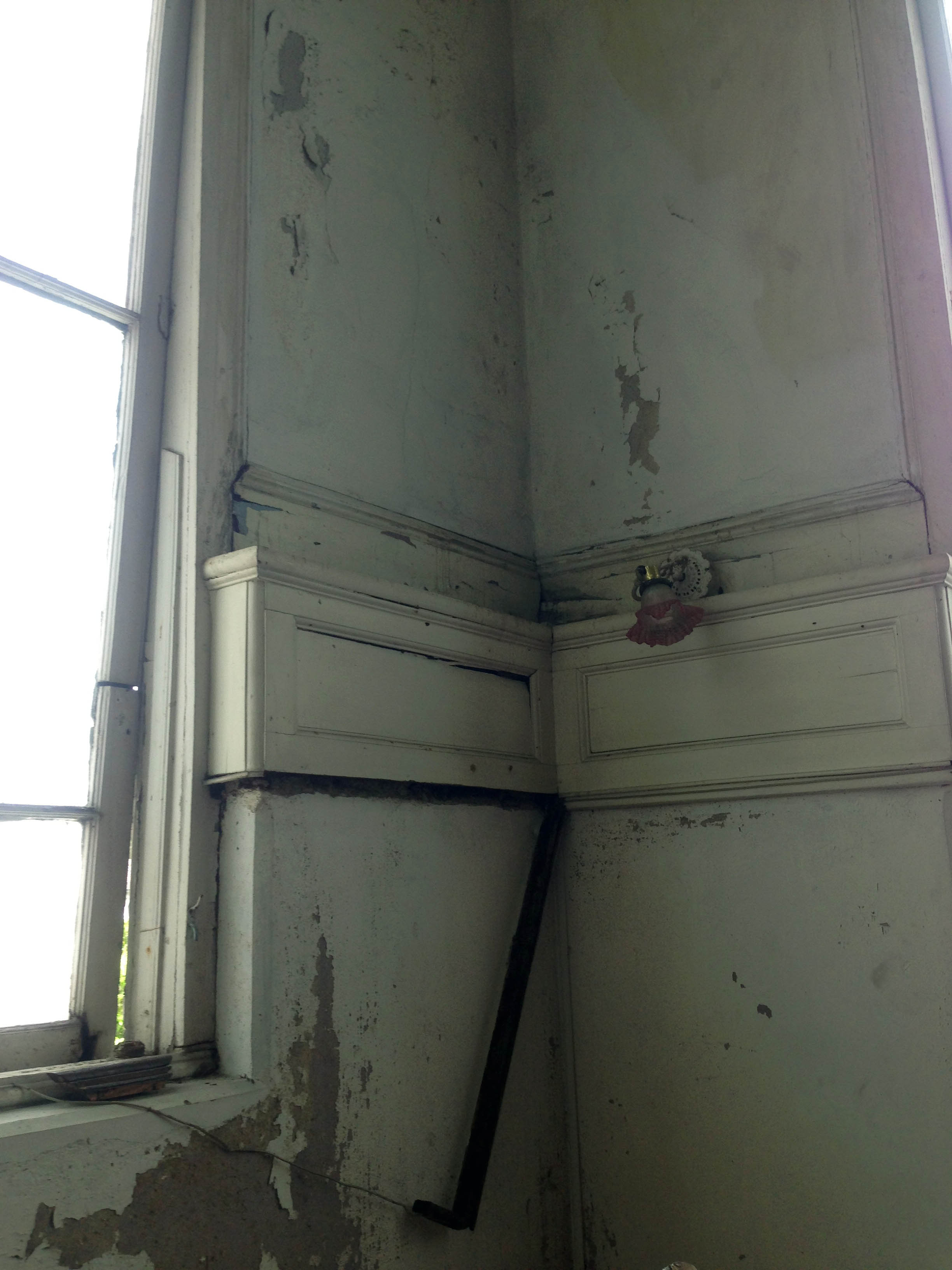 The deteriorating walls along the stairwell in Hayes Court. Photo courtesy the Hayes Court Restoration Committee.