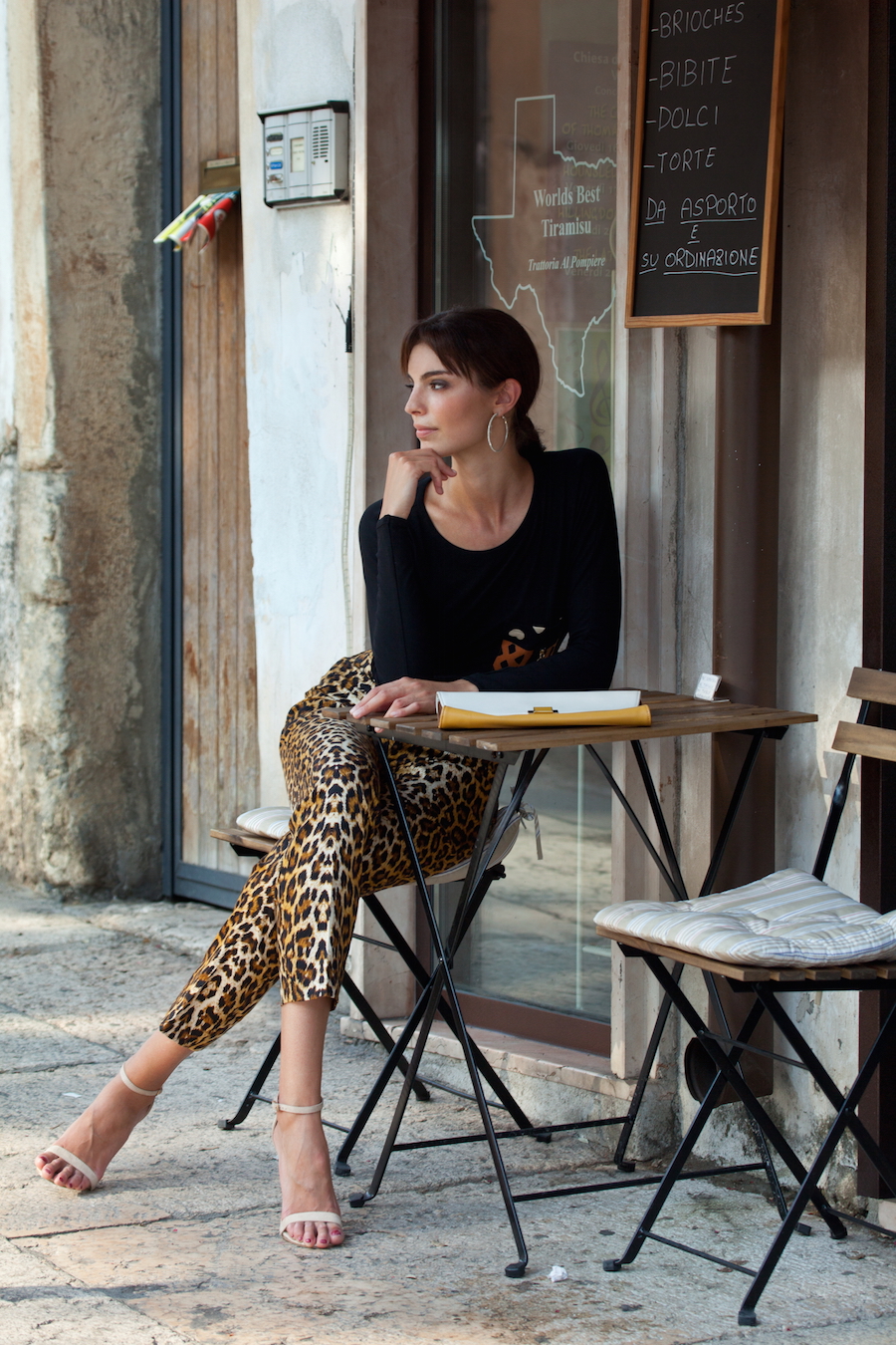 The bold simplicity of Kaj's Tribu Sauvage resort collection was captured during a 2015 Global Runway promotional photo-shoot on location in Verona, Italy. Featured are Kaj’s magyar tee with tribal pocket accents and its classic trousers with pocket accents. Photo courtesy Global Runway.