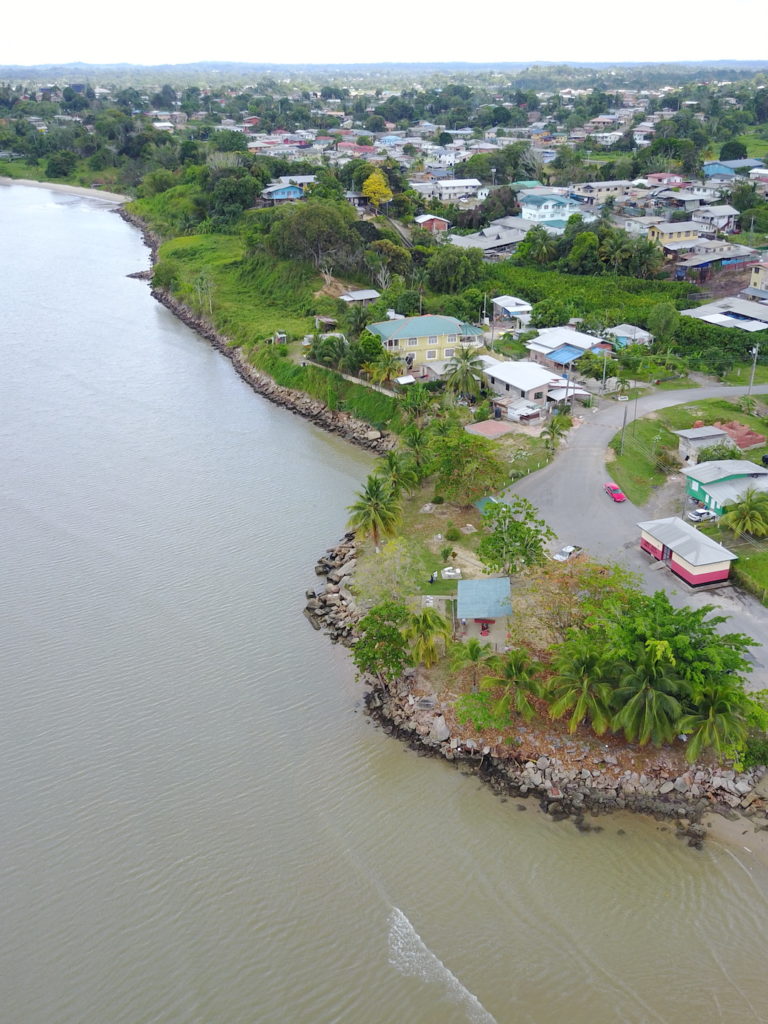 Drone image of the coast in Cap de Ville in Trinidad showing residential properties and public infrastructure which are exposed to the threats posed by coastal erosion. 