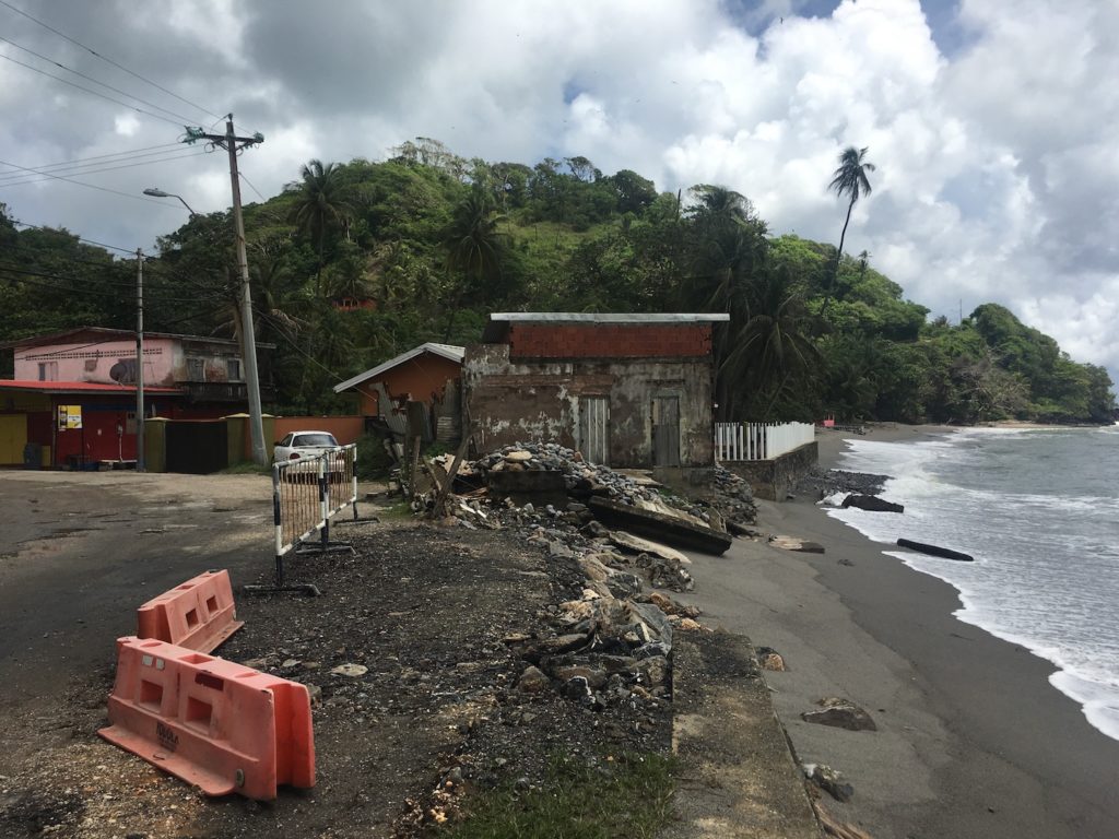 View of an arterial road being eroded along the coast in San Souci, Trinidad.